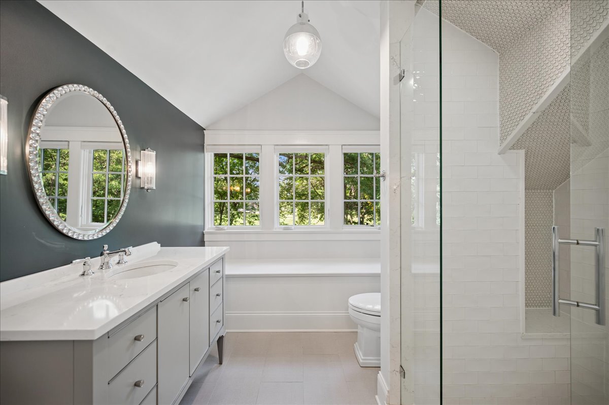 519 Cedar Street Winnetka, IL 60093 - Photo 26 of 36 a bathroom with a toilet a sink and a large mirror