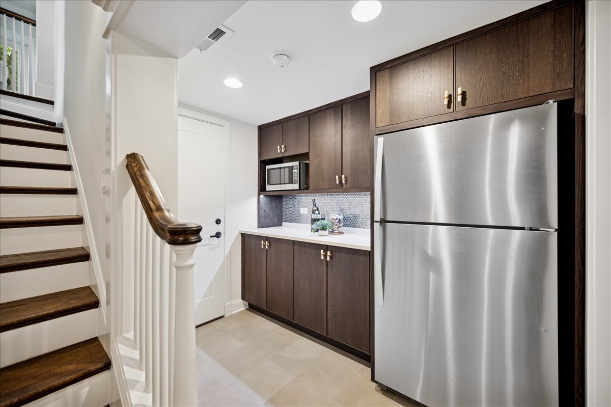 519 Cedar Street Winnetka, IL 60093 - Photo 28 of 36 a kitchen with stainless steel appliances a refrigerator and a sink