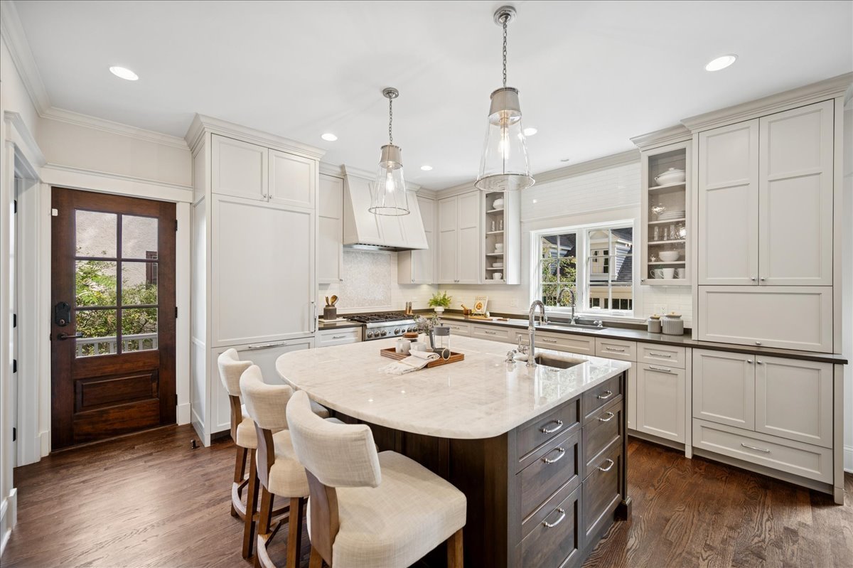 519 Cedar Street Winnetka, IL 60093 - Photo 10 of 36 a kitchen with sink a center island and chairs