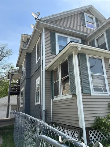 a front view of a house with parking space