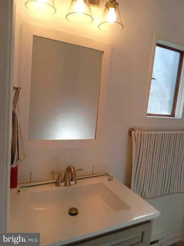 a view of an empty room with wooden floor and closet