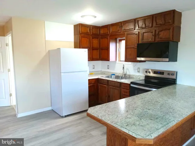a kitchen with a sink and a stove top oven