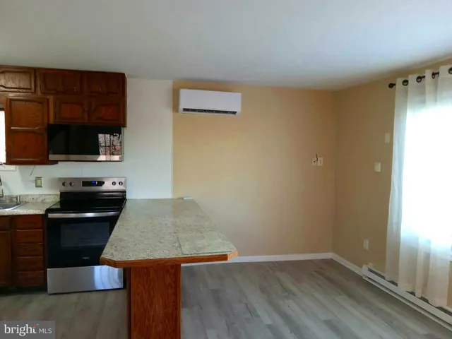 a view of a room with wooden floor and windows