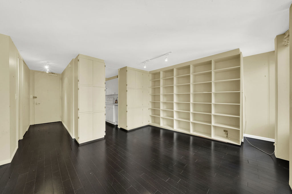 100 East Walton Street, Unit 17C Chicago, IL 60611 - Photo 7 of 21 an empty room with wooden floor and windows