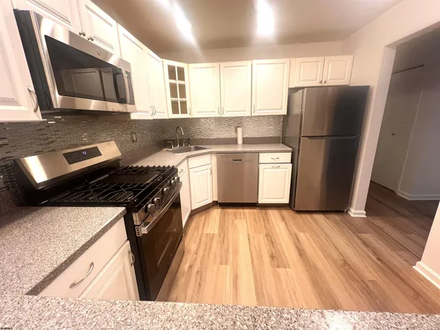 a kitchen with a refrigerator sink and microwave