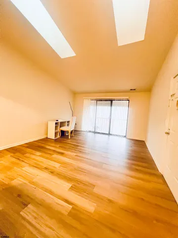 a view of a room with wooden floor