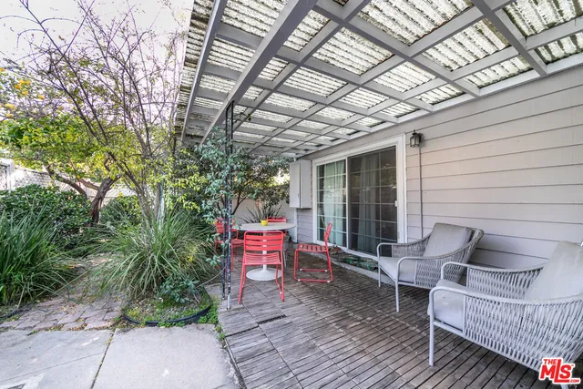 a balcony with furniture and a potted plant