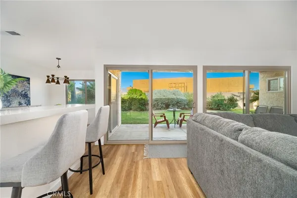 a view of a house with backyard porch and sitting area