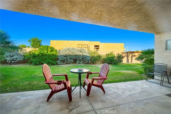 a view of a backyard with plants and a patio