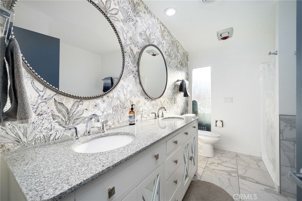 80071 Palm Cir Drive La Quinta, CA 92253 - Photo 35 of 40 a bathroom with a granite countertop toilet sink and mirror