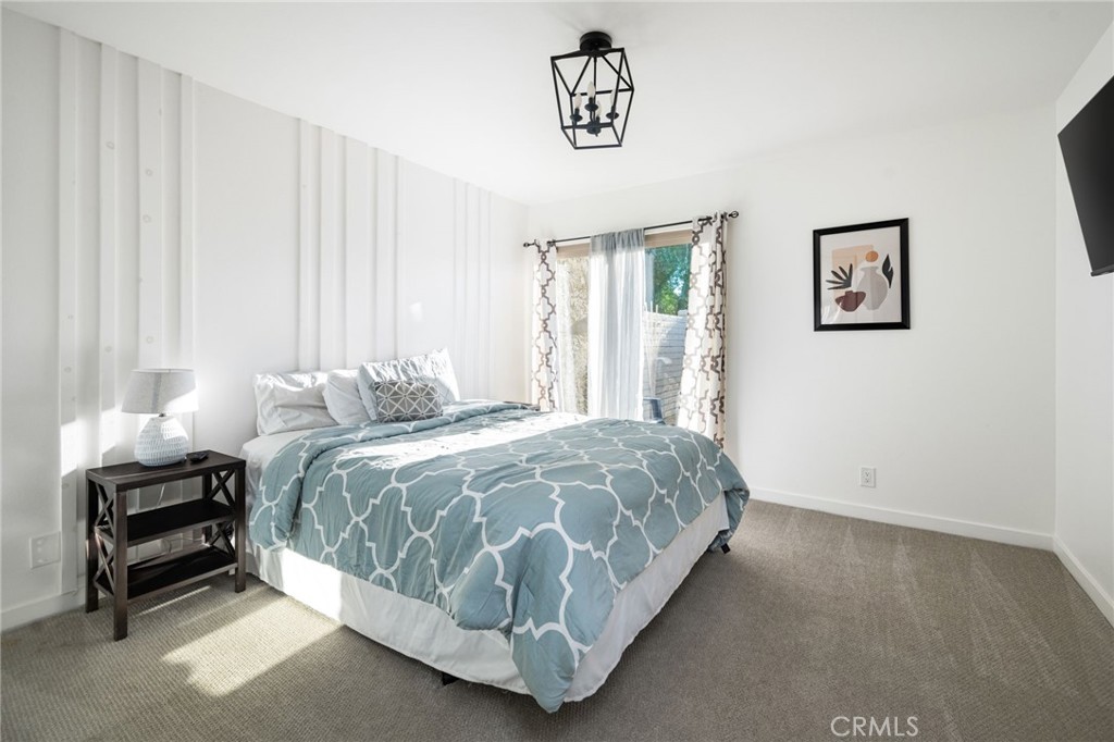 80071 Palm Cir Drive La Quinta, CA 92253 - Photo 37 of 40 a spacious bedroom with a bed and a window