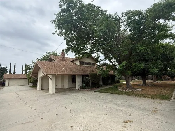 a view of a house with a tree beside it