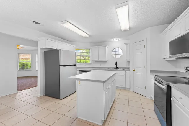 a kitchen with a sink cabinets and stainless steel appliances