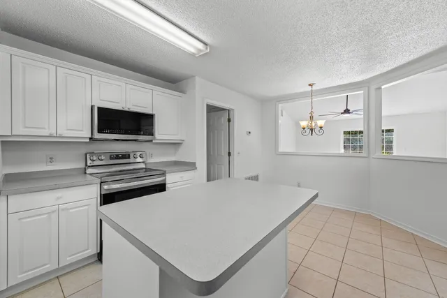 a kitchen with a stove a sink and a microwave