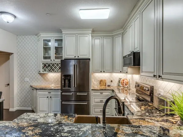 a kitchen with kitchen island granite countertop cabinets and refrigerator