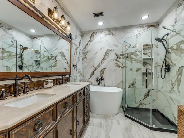 a bathroom with a double vanity sink mirror and shower
