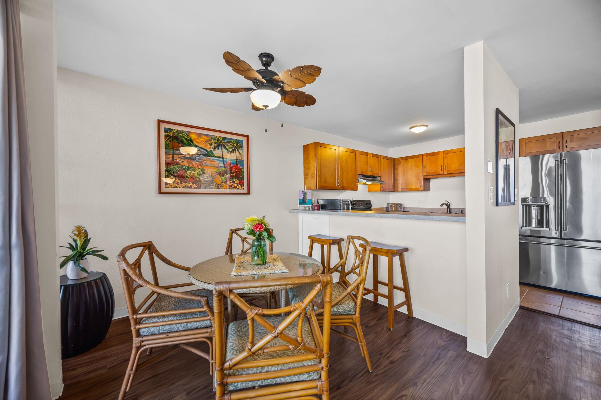 483 South Kihei Road, Unit 215 Kihei, HI 96753 - Photo 20 of 49 a view of a dining room with furniture and wooden floor