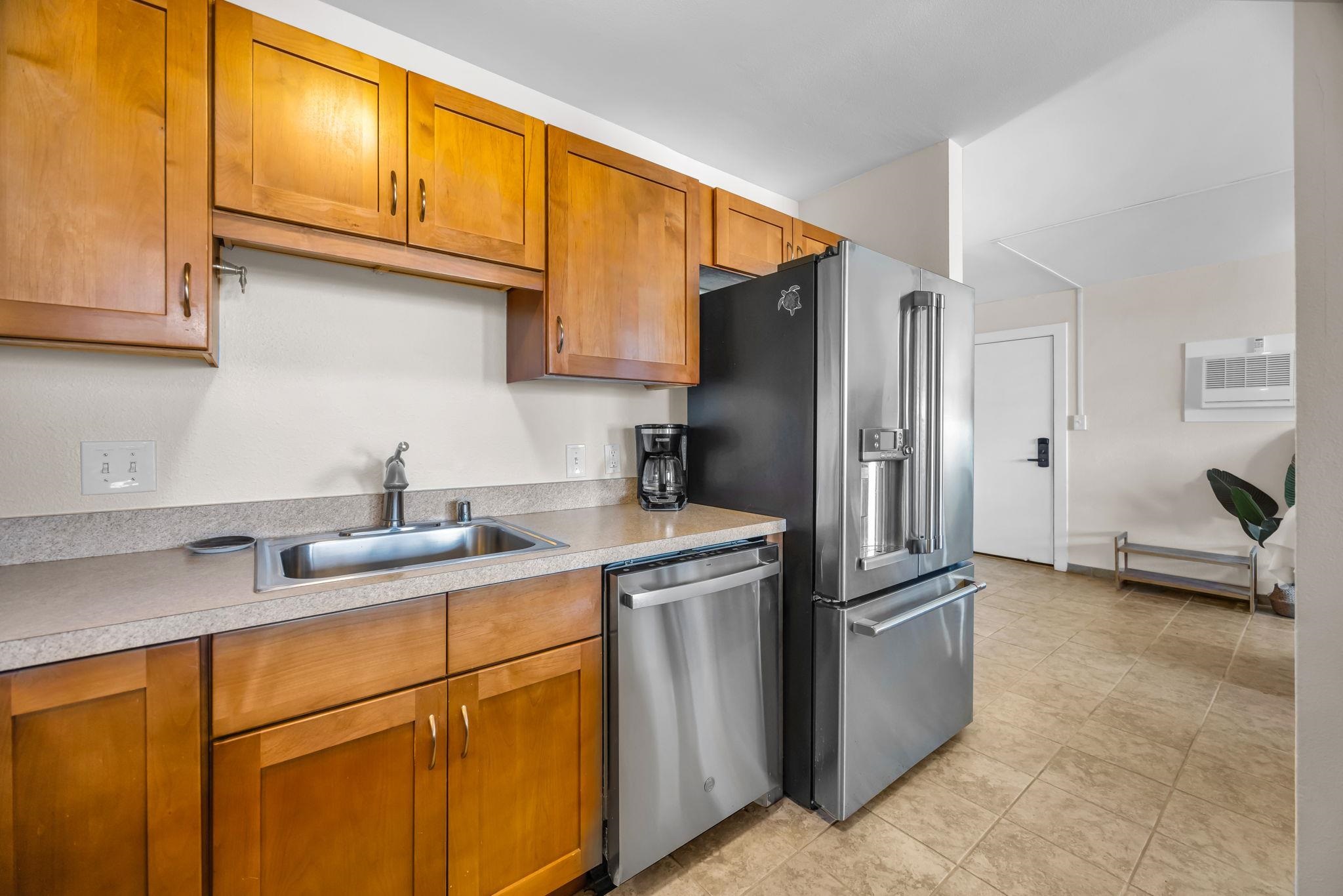 483 South Kihei Road, Unit 215 Kihei, HI 96753 - Photo 25 of 49 a kitchen with stainless steel appliances granite countertop a refrigerator a sink and cabinets