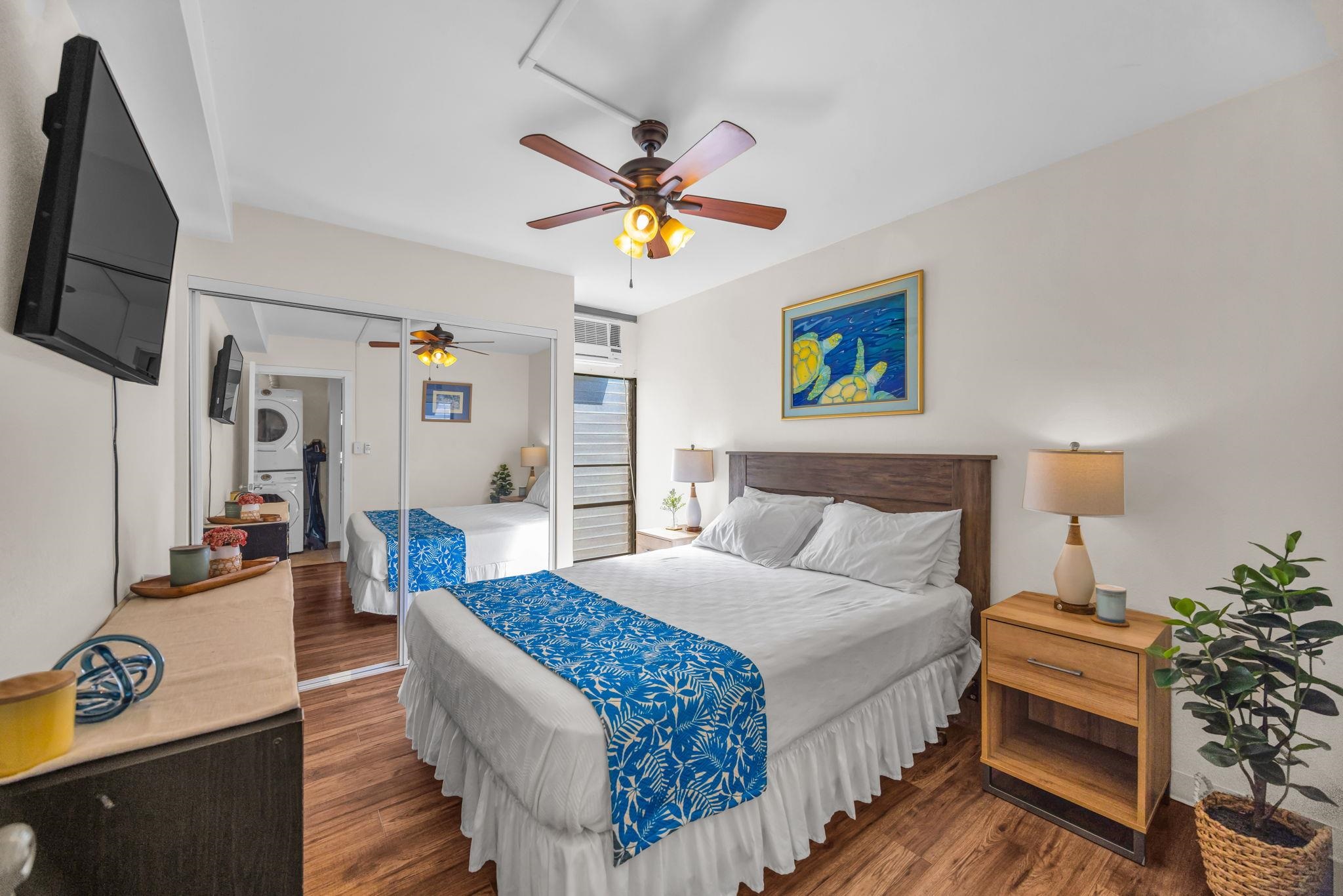 483 South Kihei Road, Unit 215 Kihei, HI 96753 - Photo 32 of 49 a bedroom with bed and a chandelier