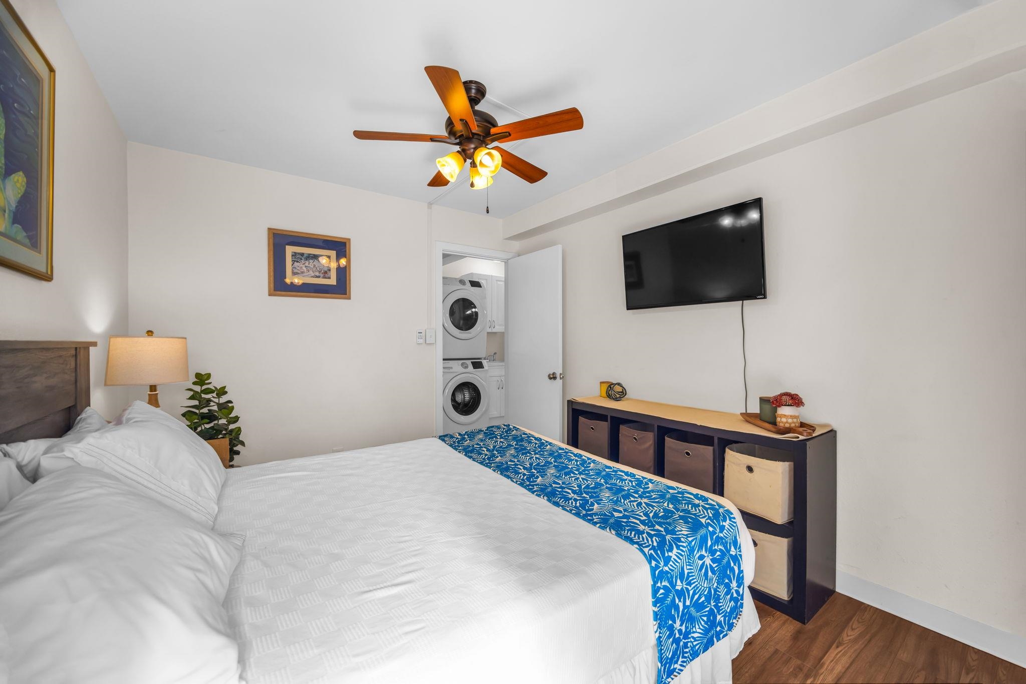 483 South Kihei Road, Unit 215 Kihei, HI 96753 - Photo 33 of 49 a bedroom with a bed a flat screen tv and a chandelier