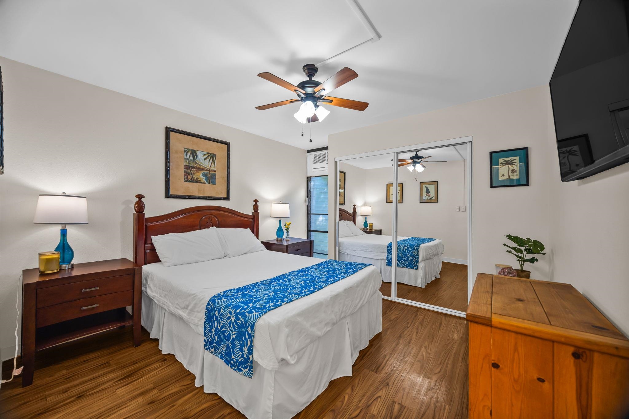 483 South Kihei Road, Unit 215 Kihei, HI 96753 - Photo 36 of 49 a bedroom with a bed and a flat tv screen on dresser