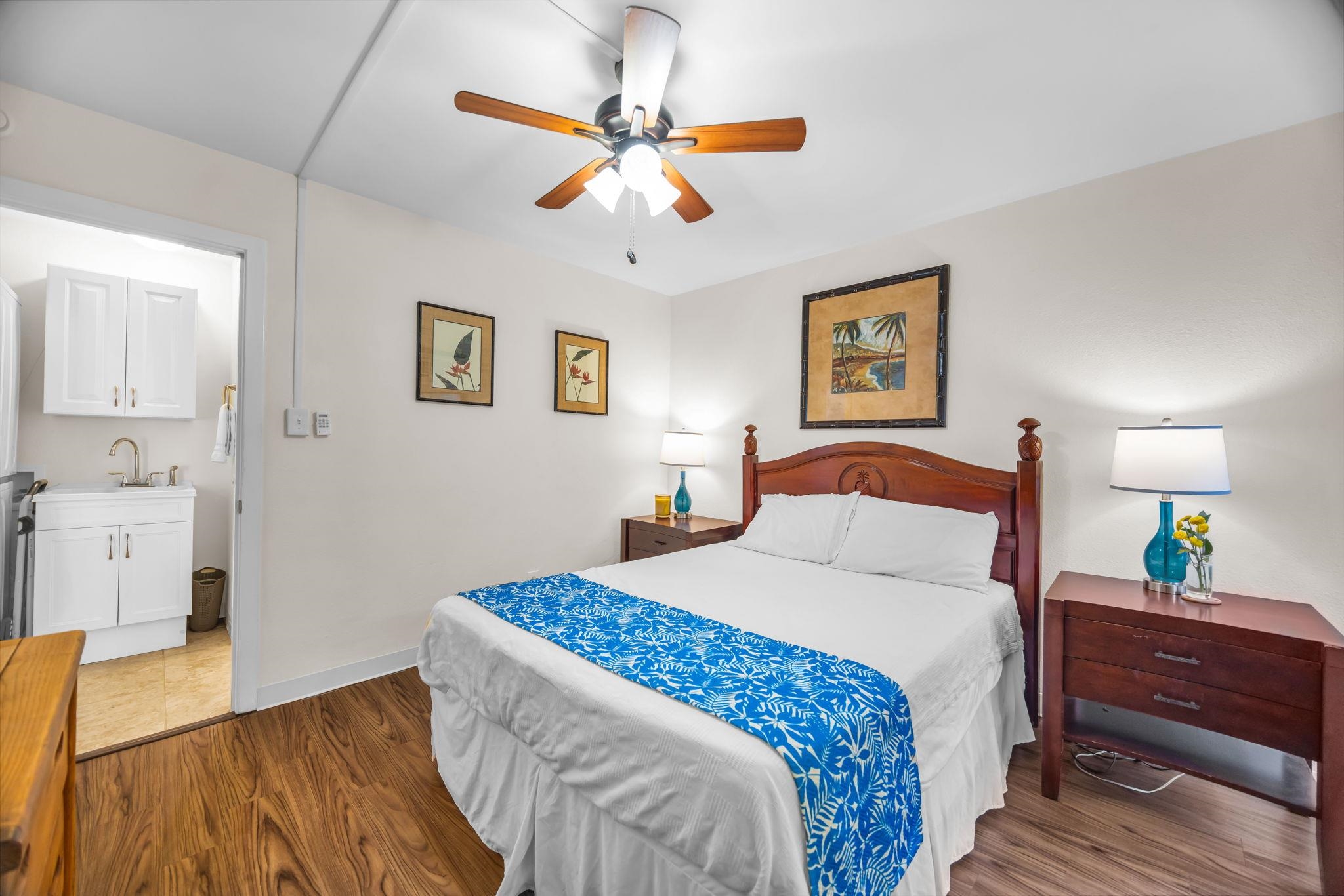 483 South Kihei Road, Unit 215 Kihei, HI 96753 - Photo 37 of 49 a bedroom with a bed and wooden floor