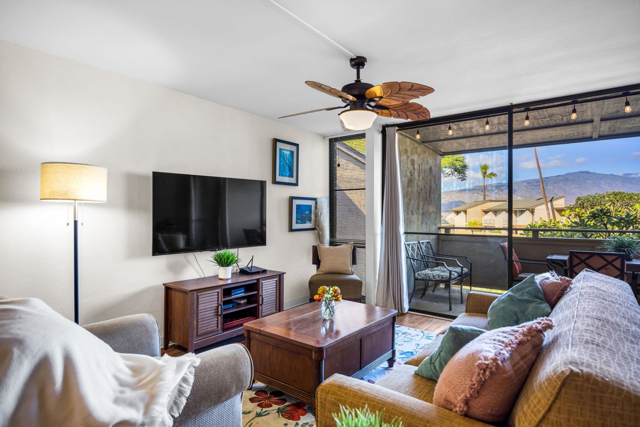 483 South Kihei Road, Unit 215 Kihei, HI 96753 - Photo 9 of 49 a living room with furniture a ceiling fan and a flat screen tv