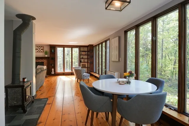 a dining room with furniture and wooden floor