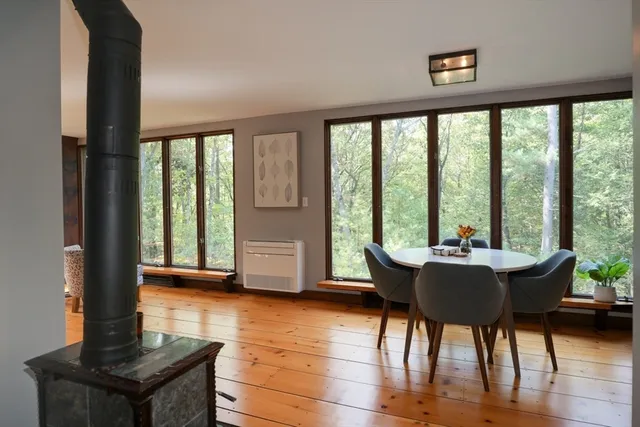a dining room with furniture and wooden floor