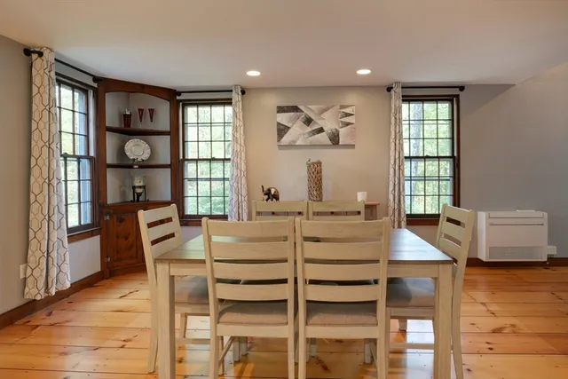 a view of a dining room with furniture a chandelier and wooden floor
