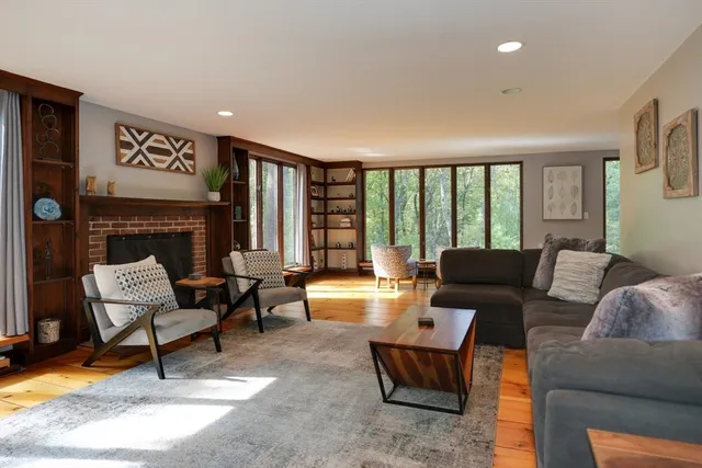a living room with furniture and a fireplace