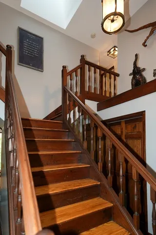a view of entryway and hall with wooden floor