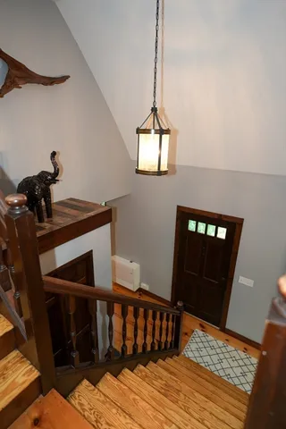 a view of a hallway with furniture and front door