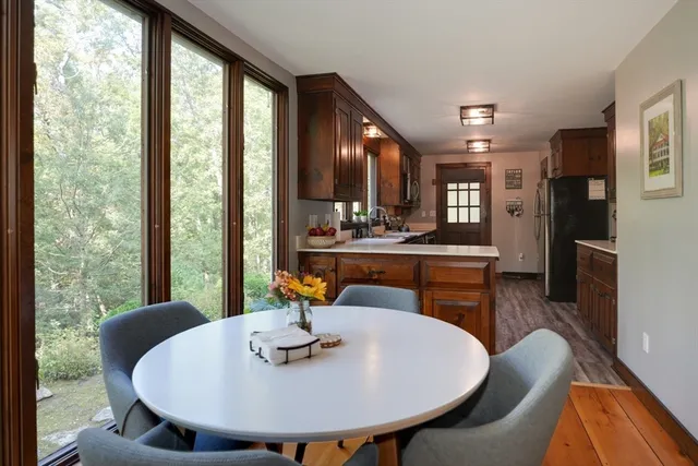a view of a dining room with furniture window and wooden floor
