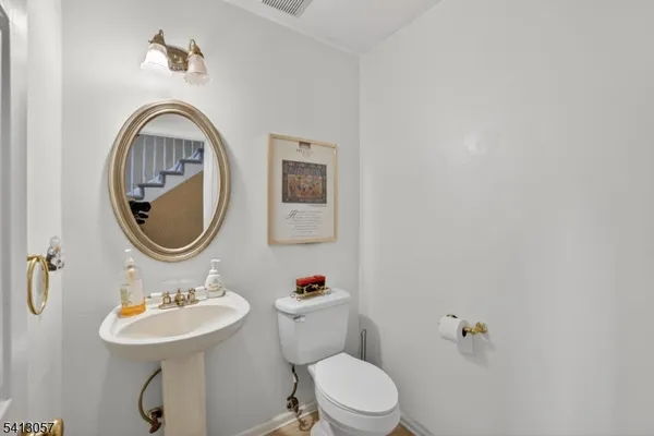 a bathroom with a toilet a sink and a mirror