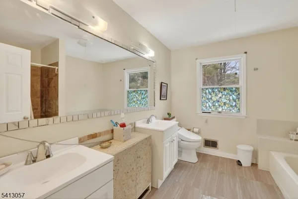 a bathroom with a sink toilet and a mirror