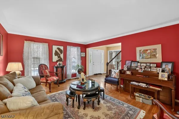 a living room with furniture a rug and a large window