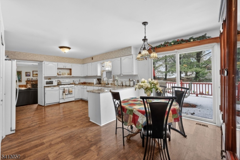 3 Turnburry Road Washington, NJ 07882 - Photo 7 of 24 a dining room with furniture and a floor to ceiling window