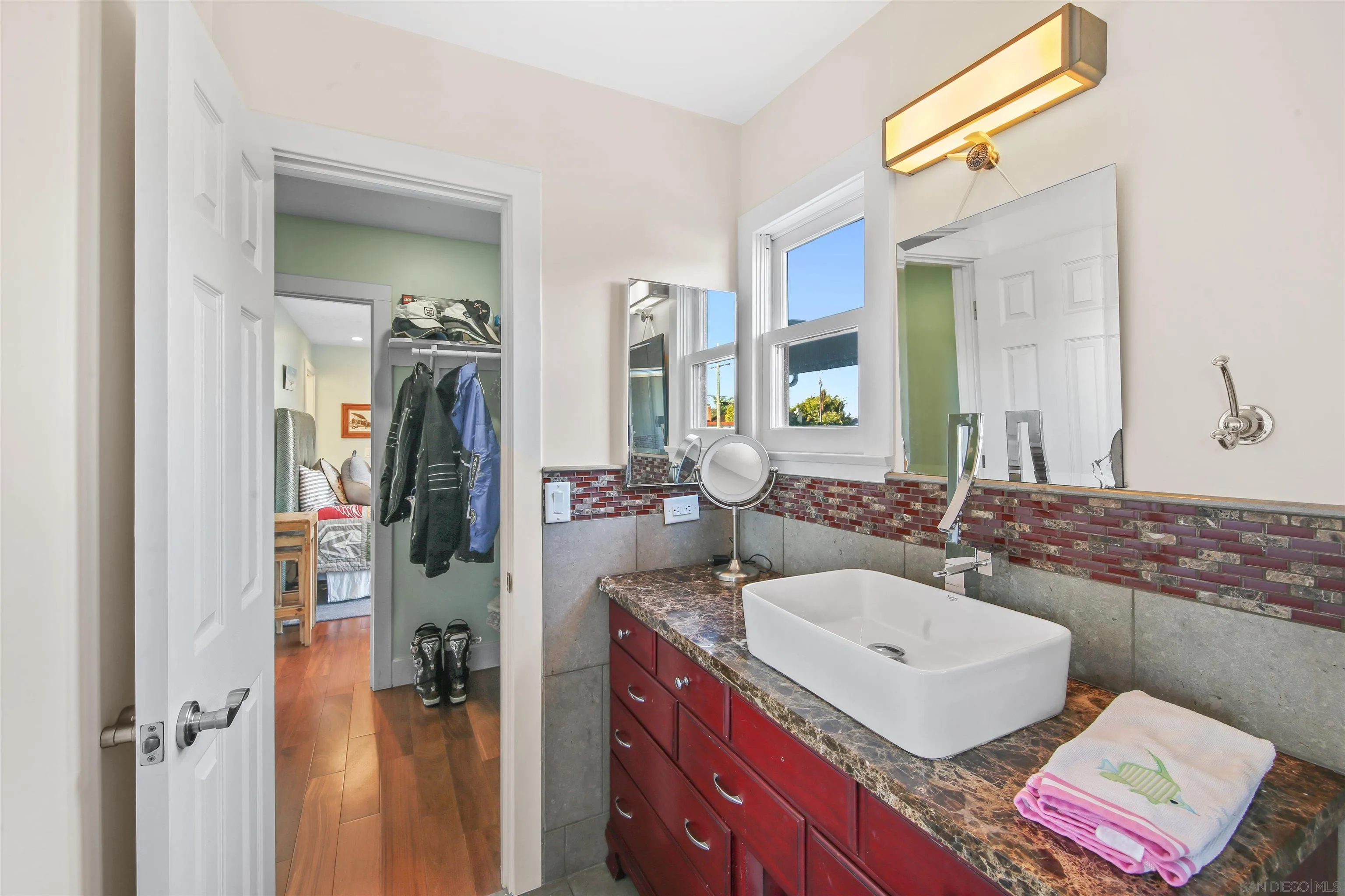 671 B Avenue Coronado, CA 92118 - Photo 23 of 41 a bathroom with a sink a mirror and a shower
