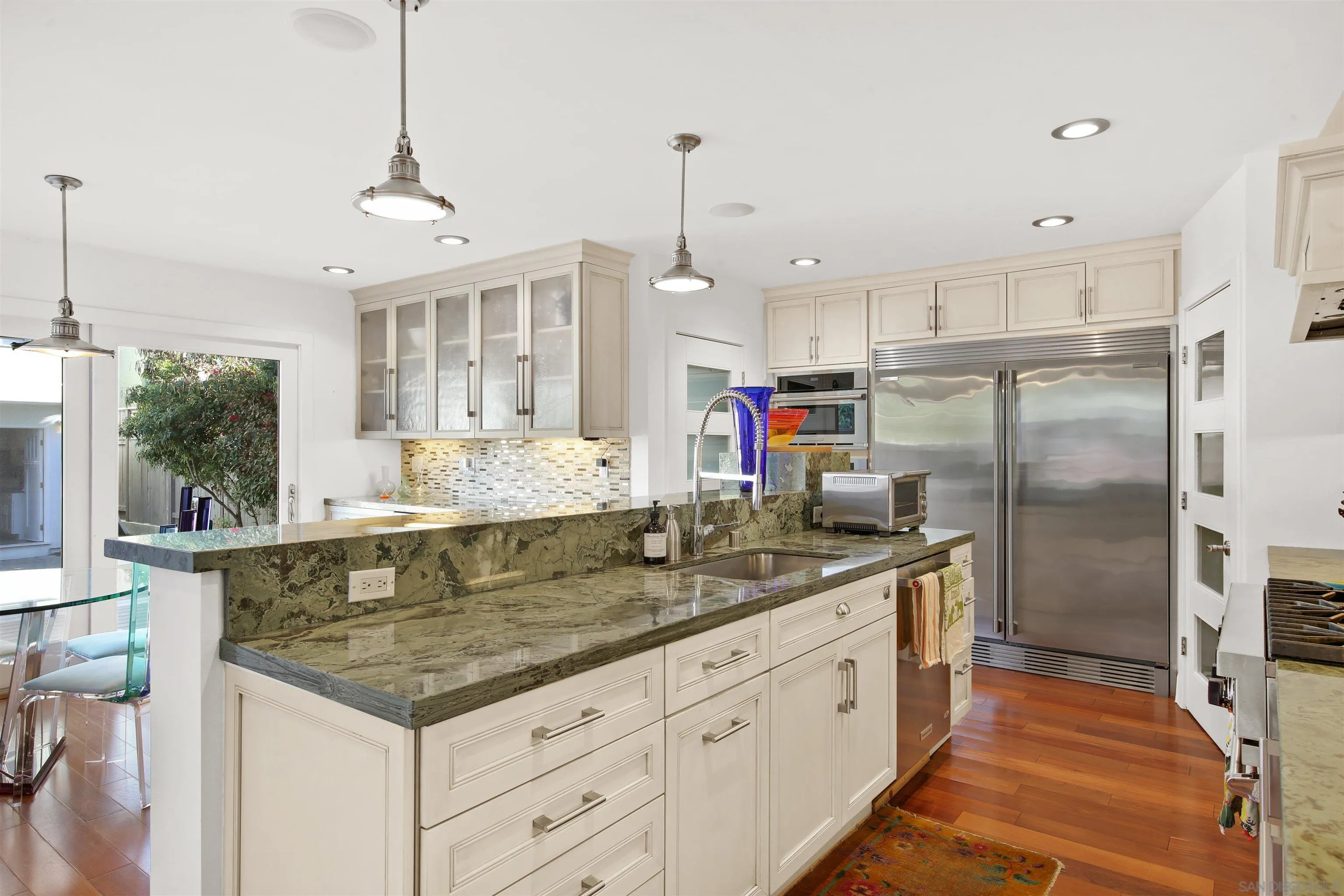 671 B Avenue Coronado, CA 92118 - Photo 7 of 41 a kitchen with stainless steel appliances granite countertop a stove a refrigerator and a sink