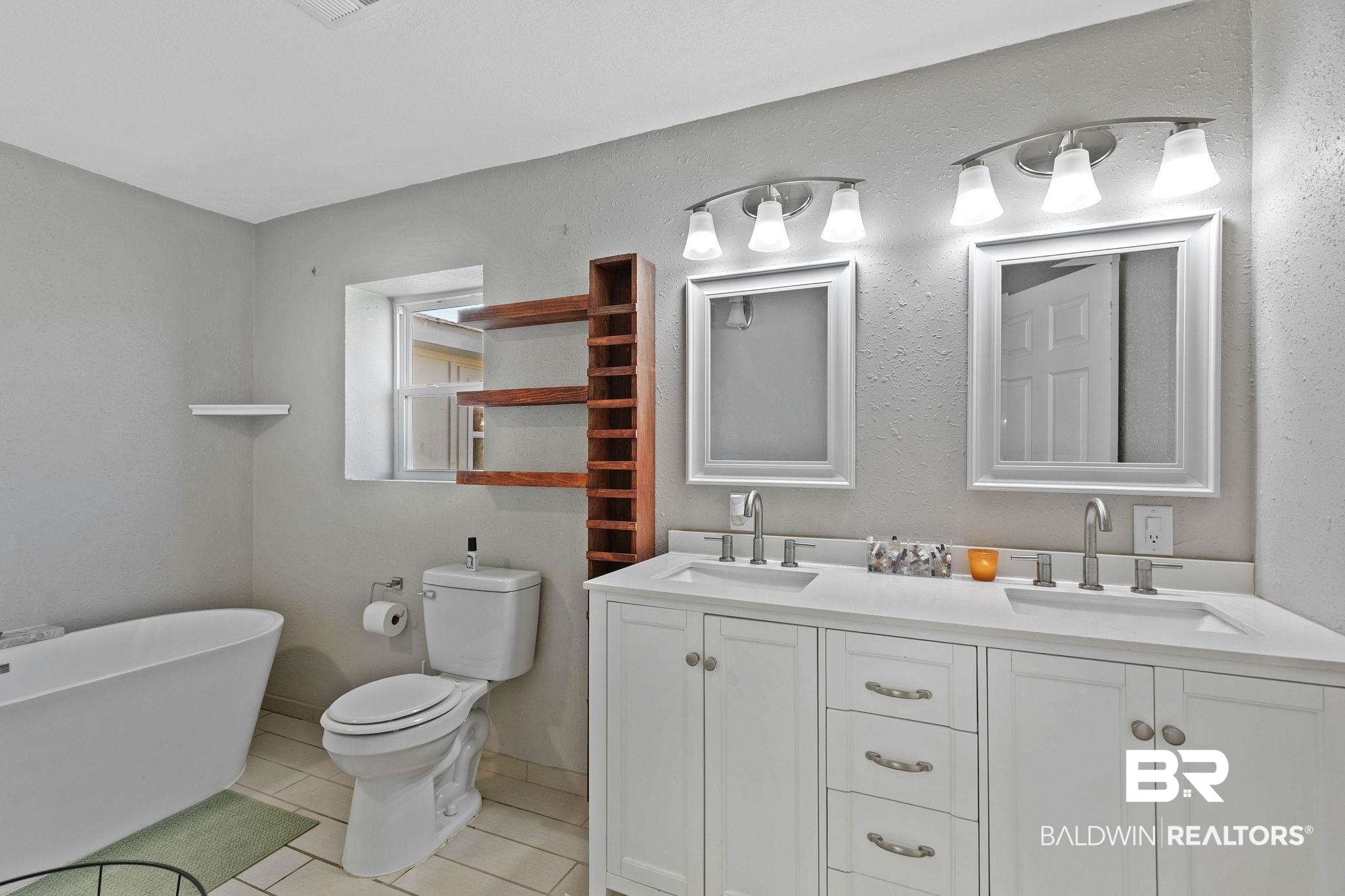 16796 Thompson Road Loxley, AL 36551 - Photo 41 of 93 Full bathroom with light tile patterned floors, a soaking tub, and double vanity