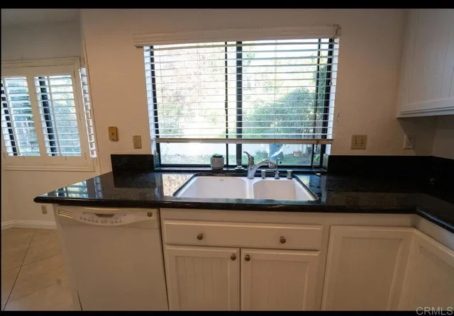 a kitchen with a sink and large window