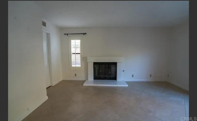 an empty room with a fireplace