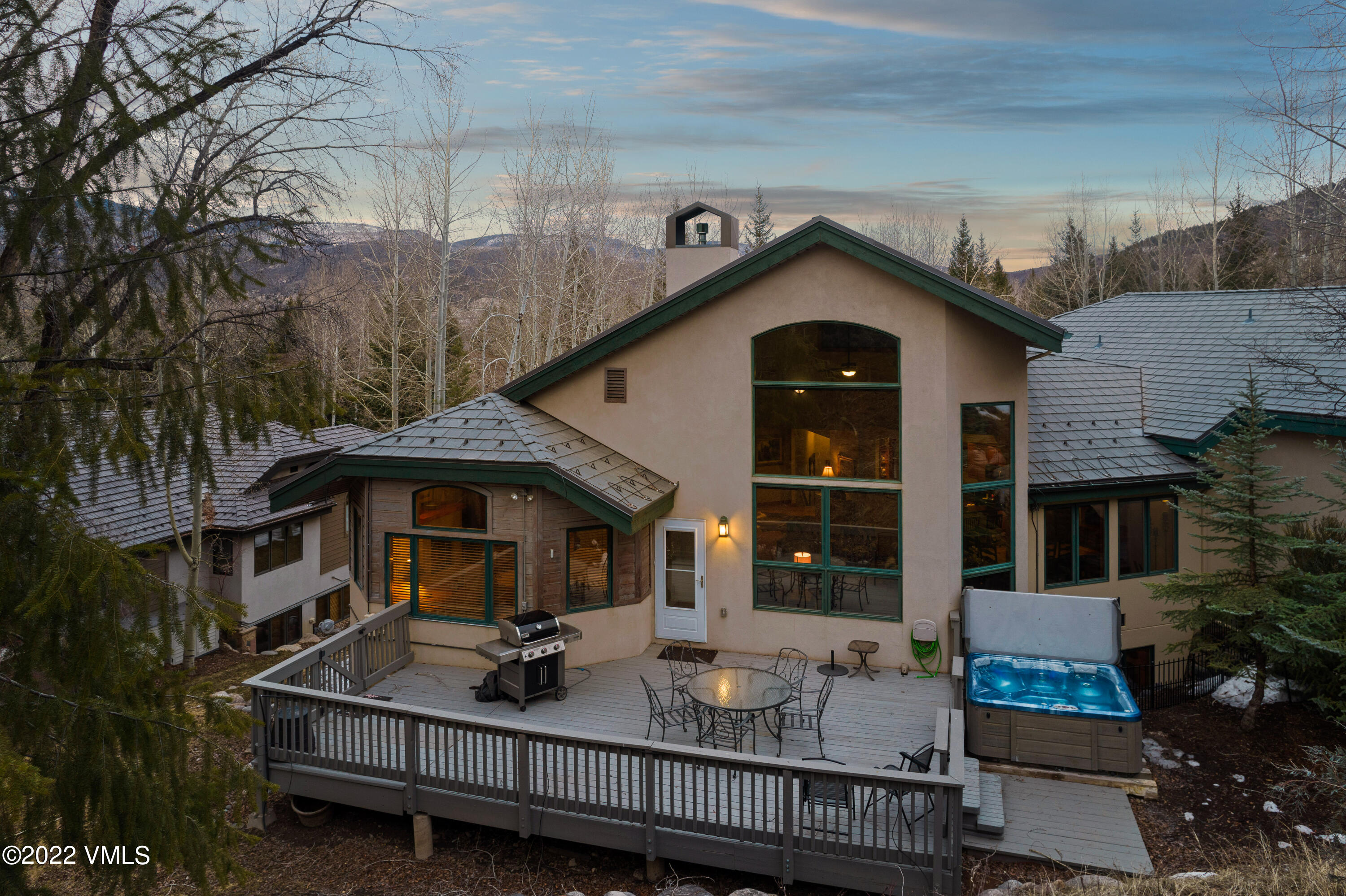a front view of house with deck and outdoor seating