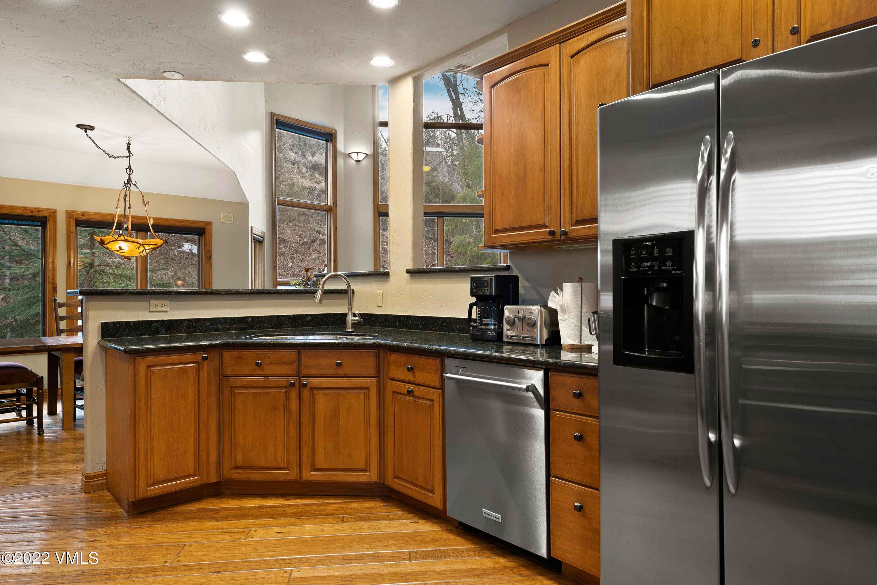 254 Arrowhead Drive, Unit B Edwards, CO 81632 - Photo 11 of 45 a kitchen with stainless steel appliances granite countertop a refrigerator a sink and a stove