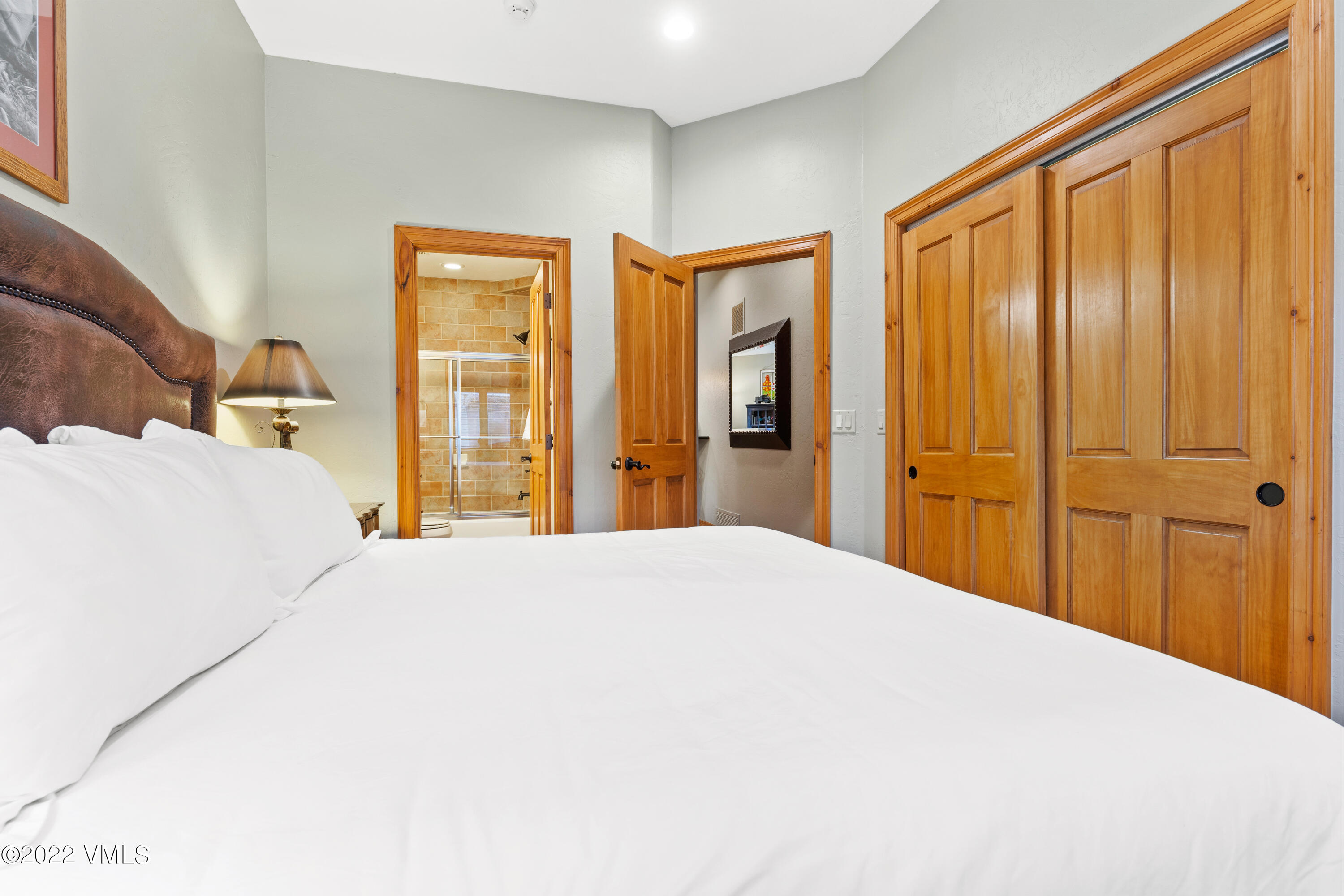 254 Arrowhead Drive, Unit B Edwards, CO 81632 - Photo 23 of 45 a bedroom with a bed and wooden floor