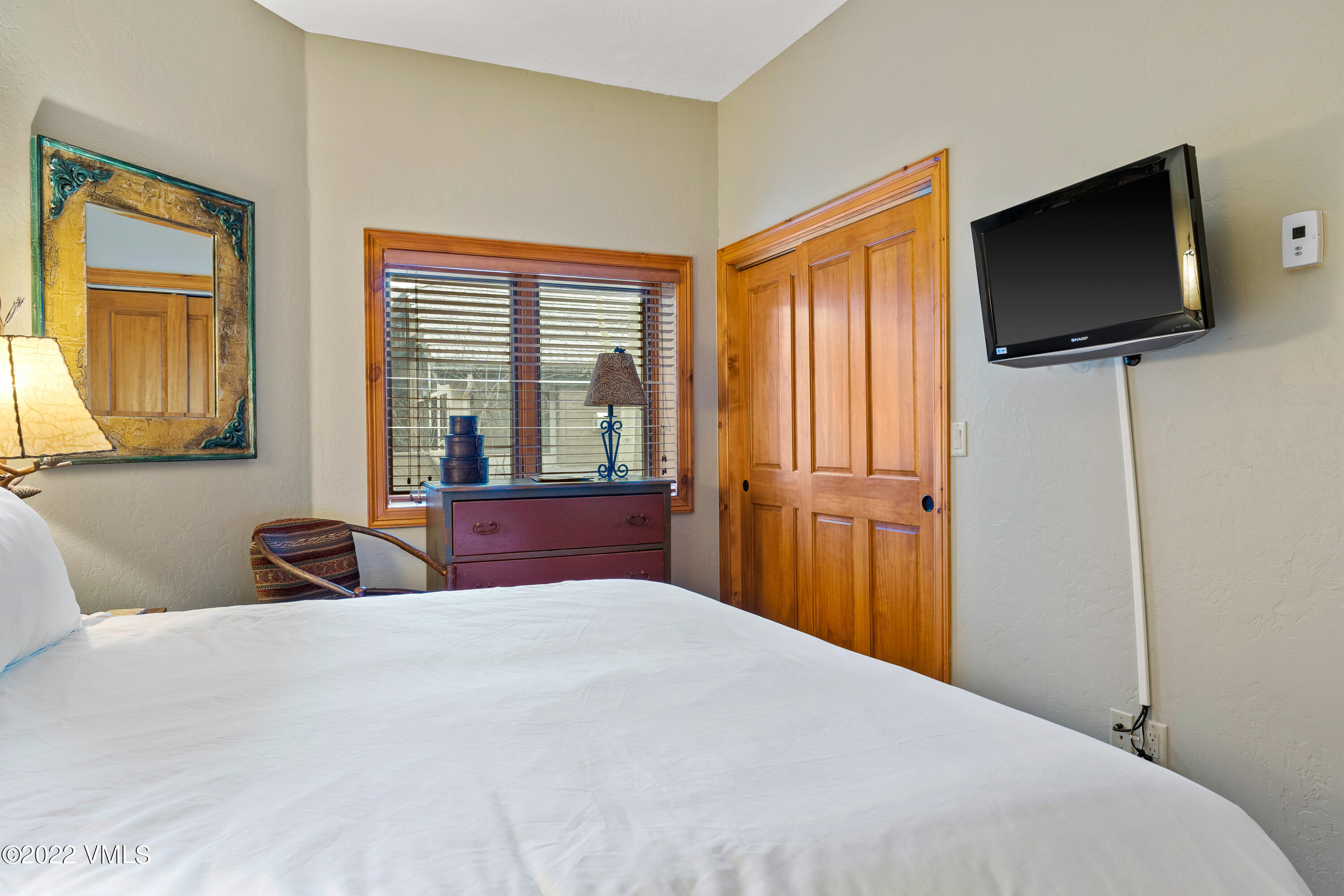 254 Arrowhead Drive, Unit B Edwards, CO 81632 - Photo 26 of 45 a bedroom with a bed and a flat tv screen on dresser