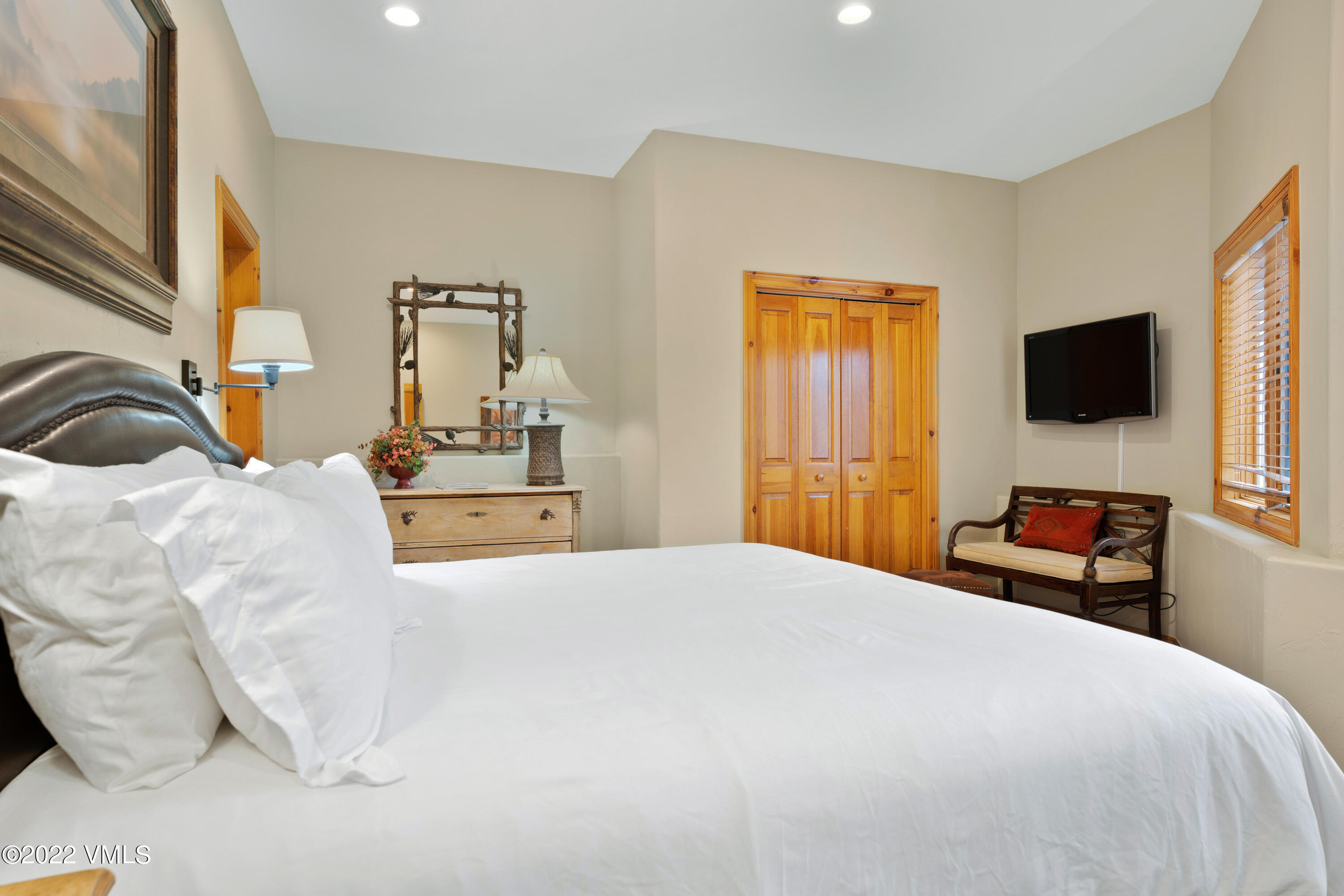 254 Arrowhead Drive, Unit B Edwards, CO 81632 - Photo 29 of 45 a bedroom with a bed and a flat screen tv