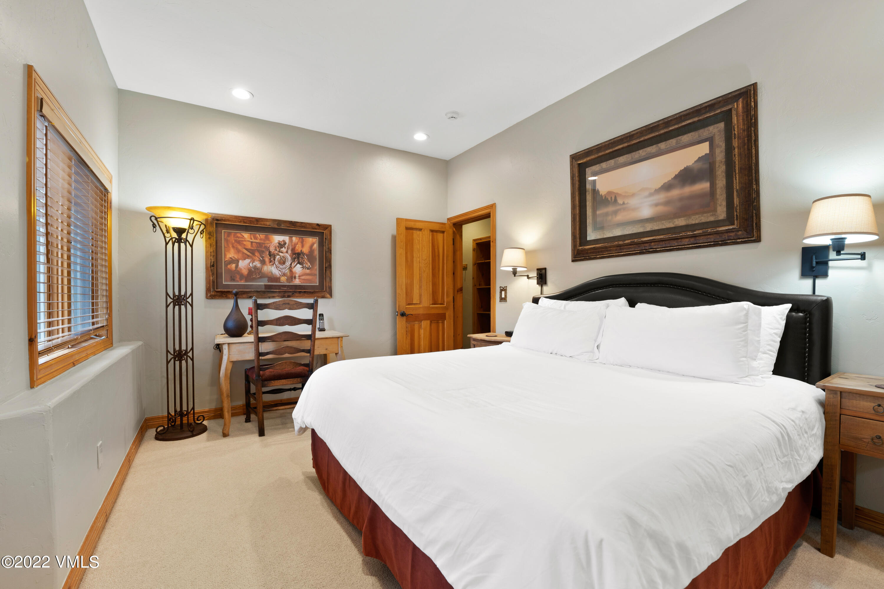 254 Arrowhead Drive, Unit B Edwards, CO 81632 - Photo 30 of 45 a bedroom with a large bed and a large mirror