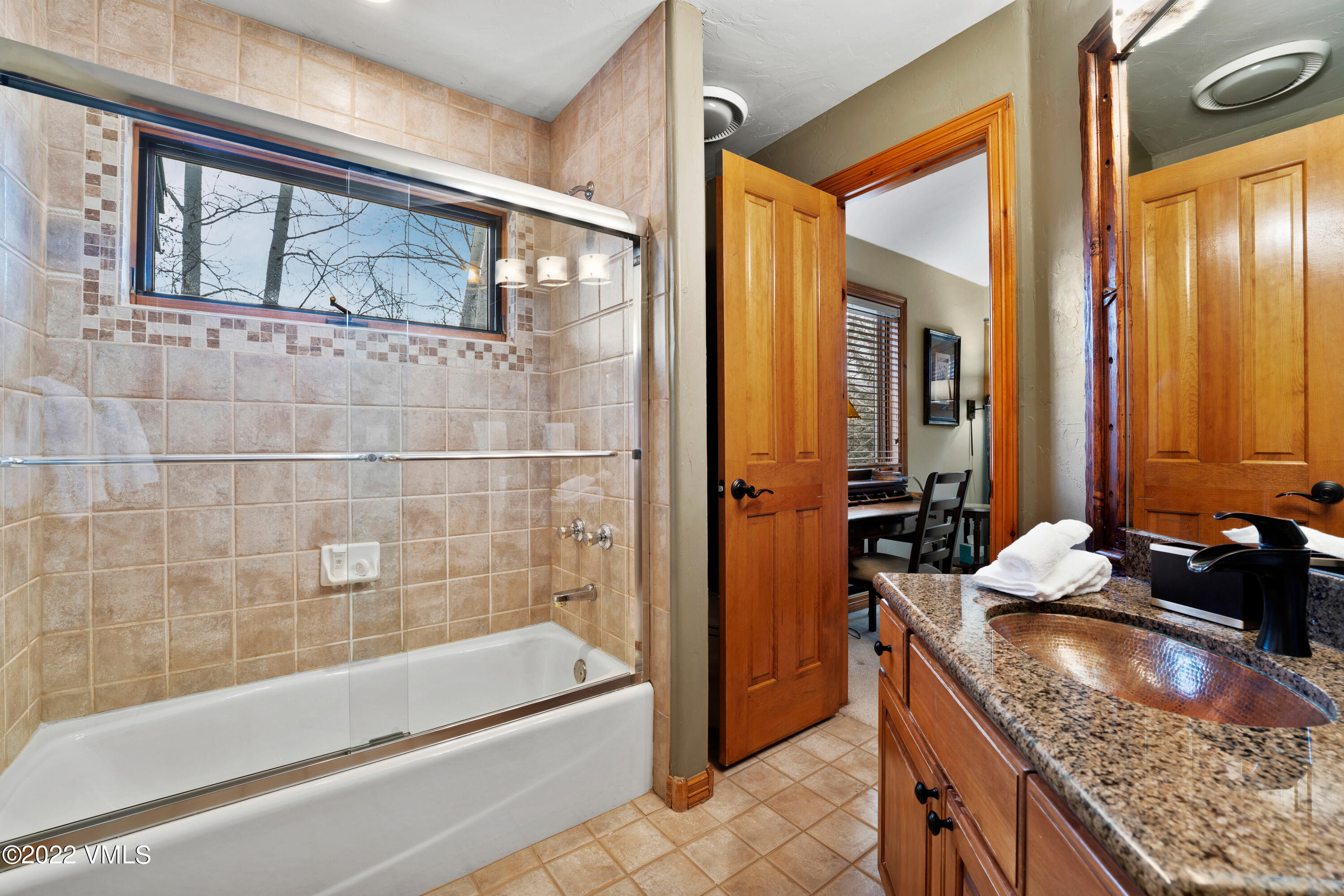 254 Arrowhead Drive, Unit B Edwards, CO 81632 - Photo 35 of 45 a bathroom with a granite countertop tub sink and mirror